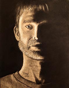 A dark, contrasty self portrait in charcoal