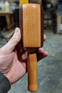A round carving mallet with purpleheart accents